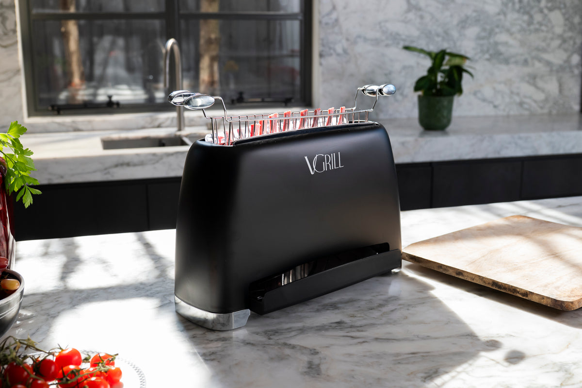 Black VGrill vertical grill cooking pork chops in a modern kitchen
