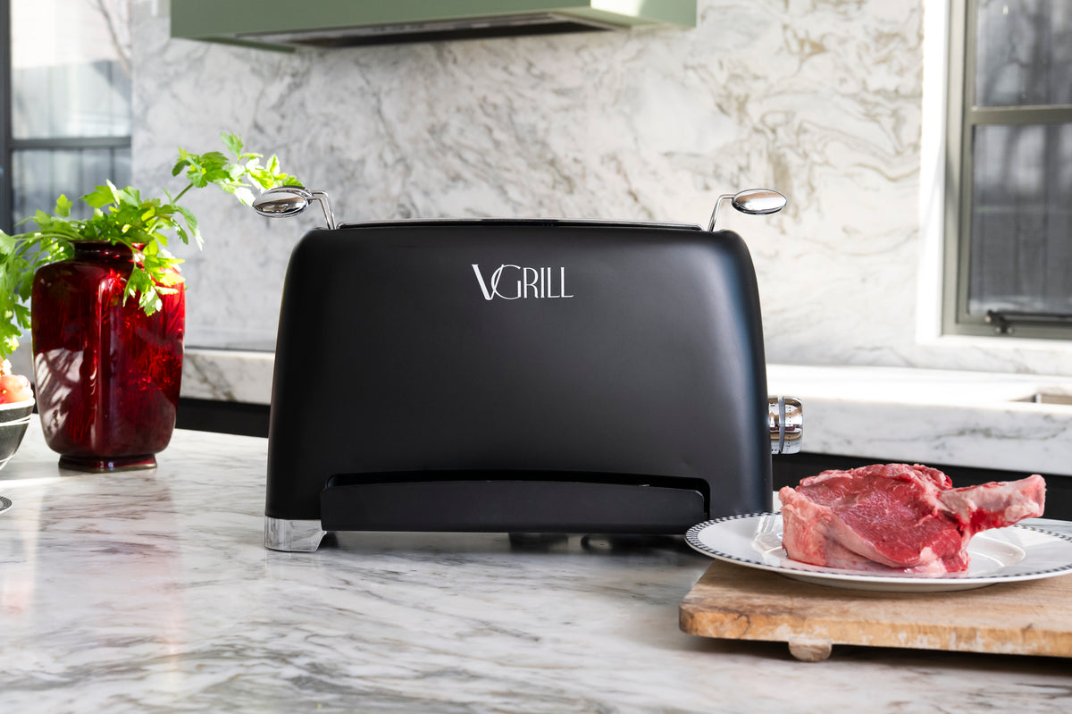 Black VGrill vertical grill with a bone-in steak in a modern kitchen