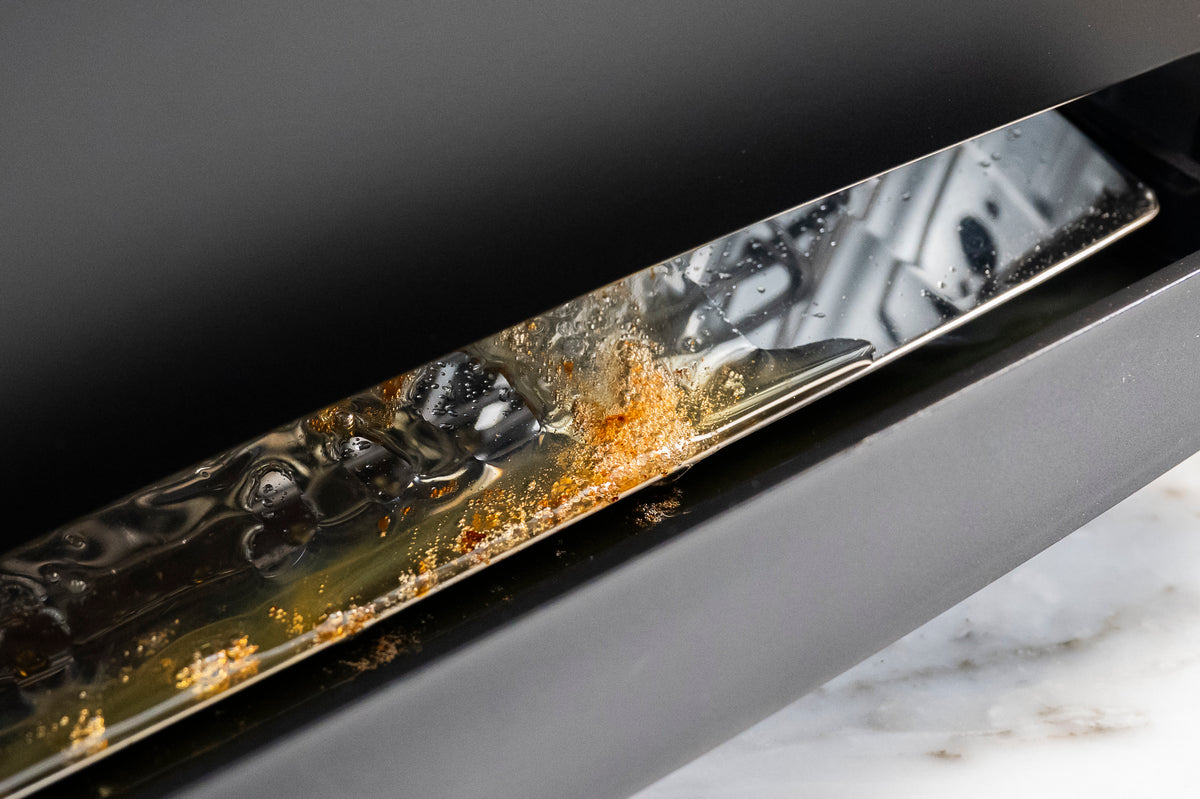 Close-up of the VGrill drip tray collecting oils and fats released from food during grilling