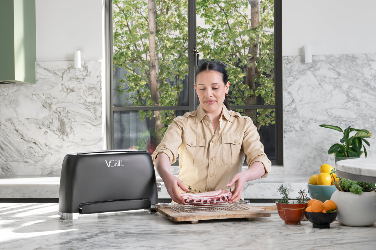 Effortlessly preparing pork chops with the VGrill vertical grill in a modern kitchen